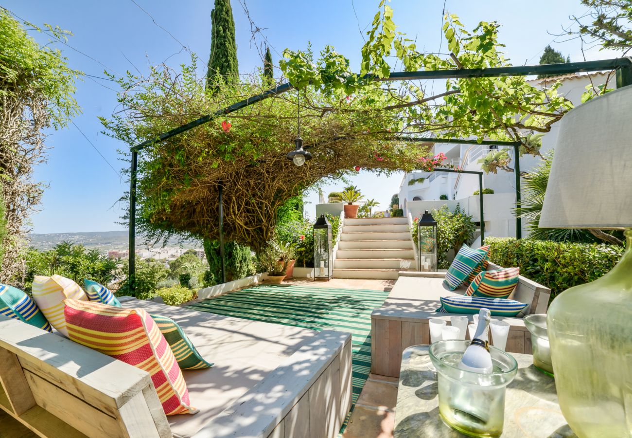 outdoor terrace with seating area with sea and city views